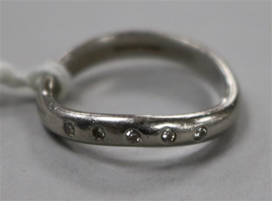 A modern platinum and five stone diamond ring, size M.